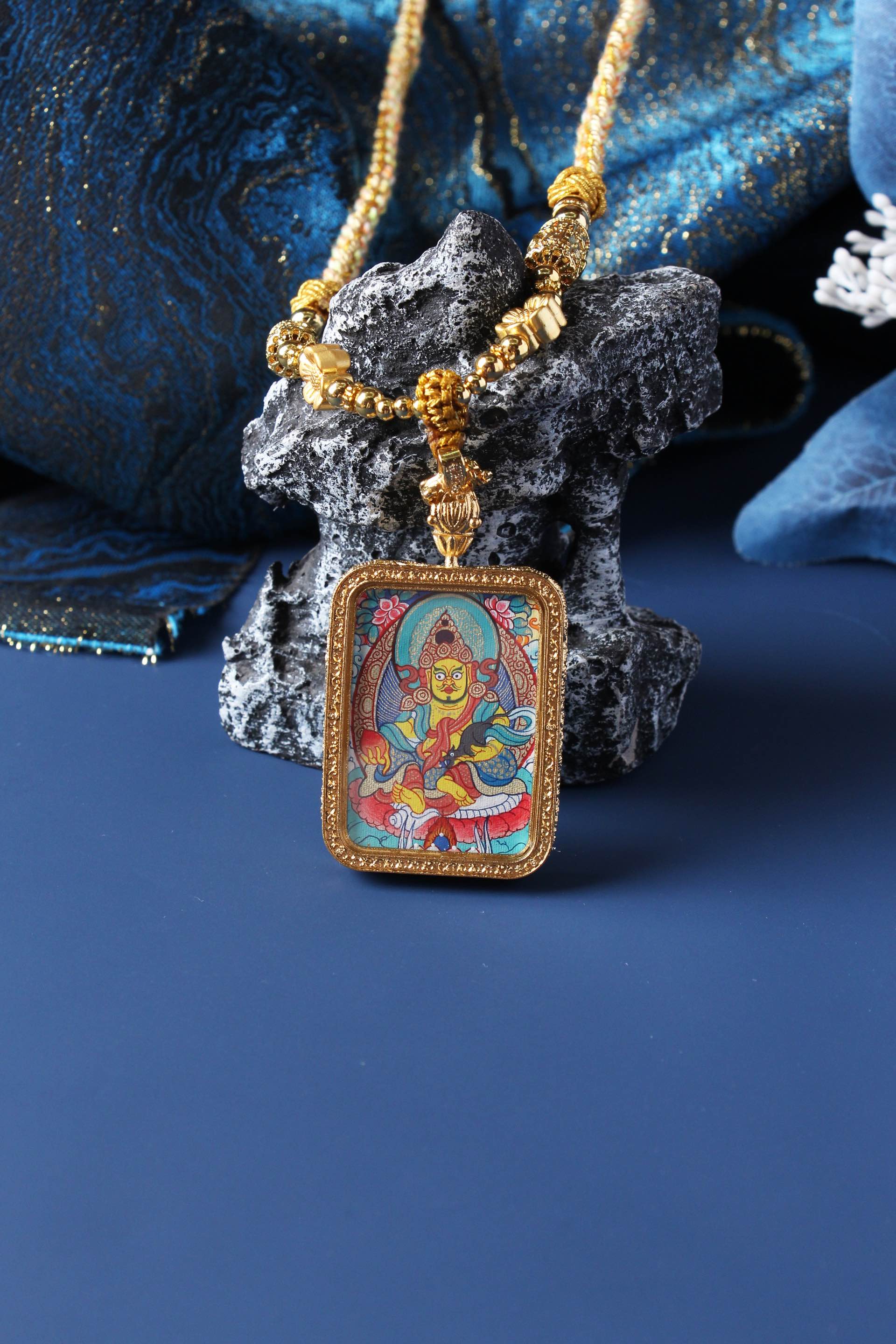 A 3.5x4.5cm hand-painted Tibetan Buddhist Yellow Jambhala Thangka pendant featuring the wealth-bestowing deity, encased in exclusive 925 Sterling Silver, representing prosperity and abundance in Tibetan Buddhist culture.

