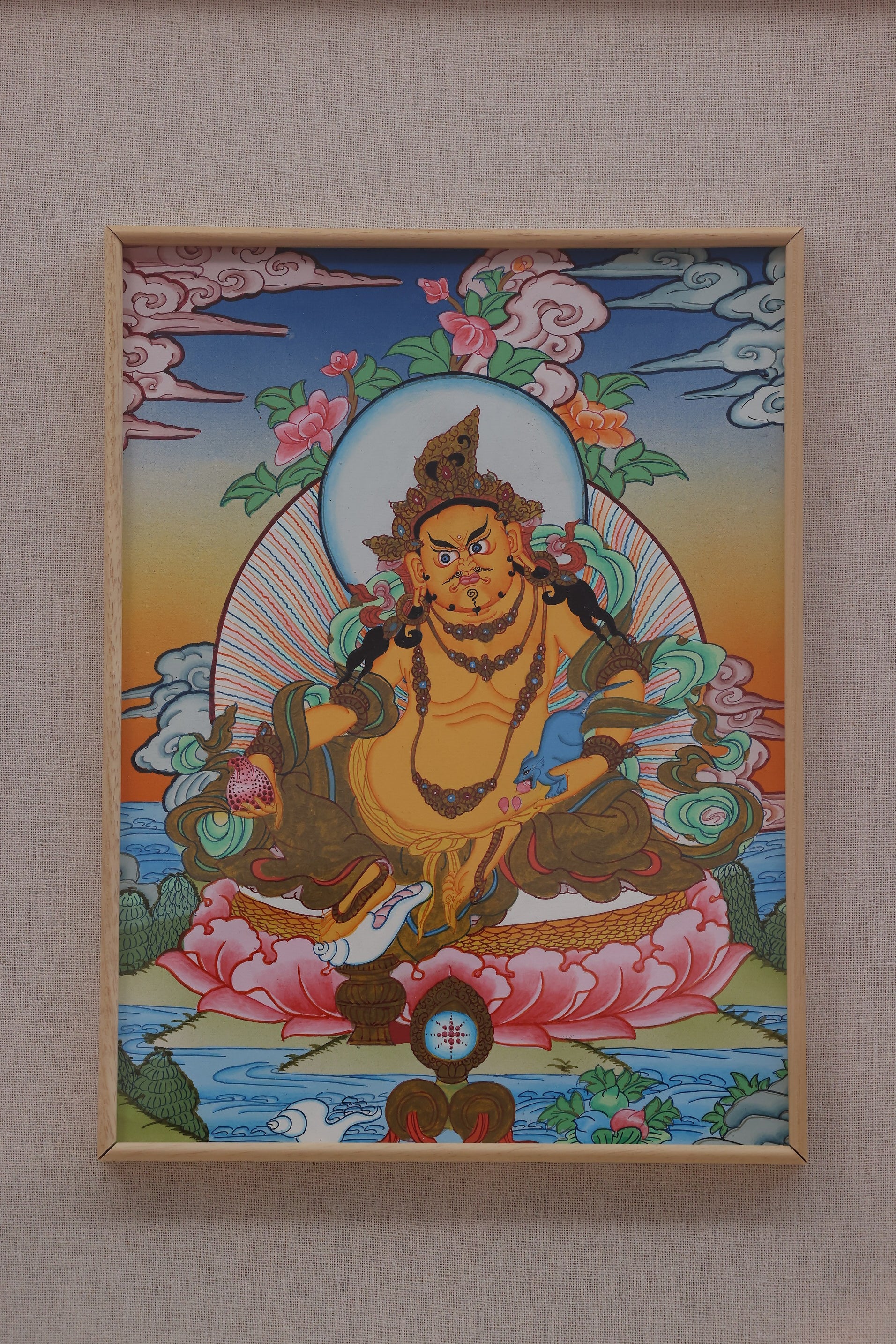 Traditional Tibetan Buddhist thangka of Yellow Jambhala, symbolizing financial blessings, success, and prosperity.