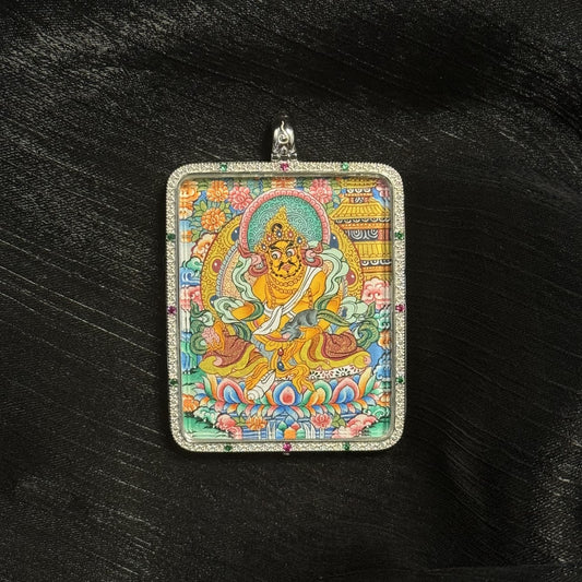  A 4x5cm hand-painted Yellow Jambhala with Mandala Thangka pendant featuring the chief of wealth deities, representing right wealth and career in Tibetan Buddhist tradition.
