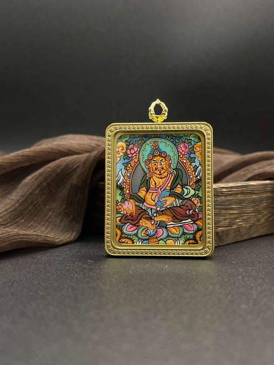  Detailed view of the titanium casing for the Yellow Jambhala Thangka pendant, symbolising wealth and tradition in Buddhist practice.

