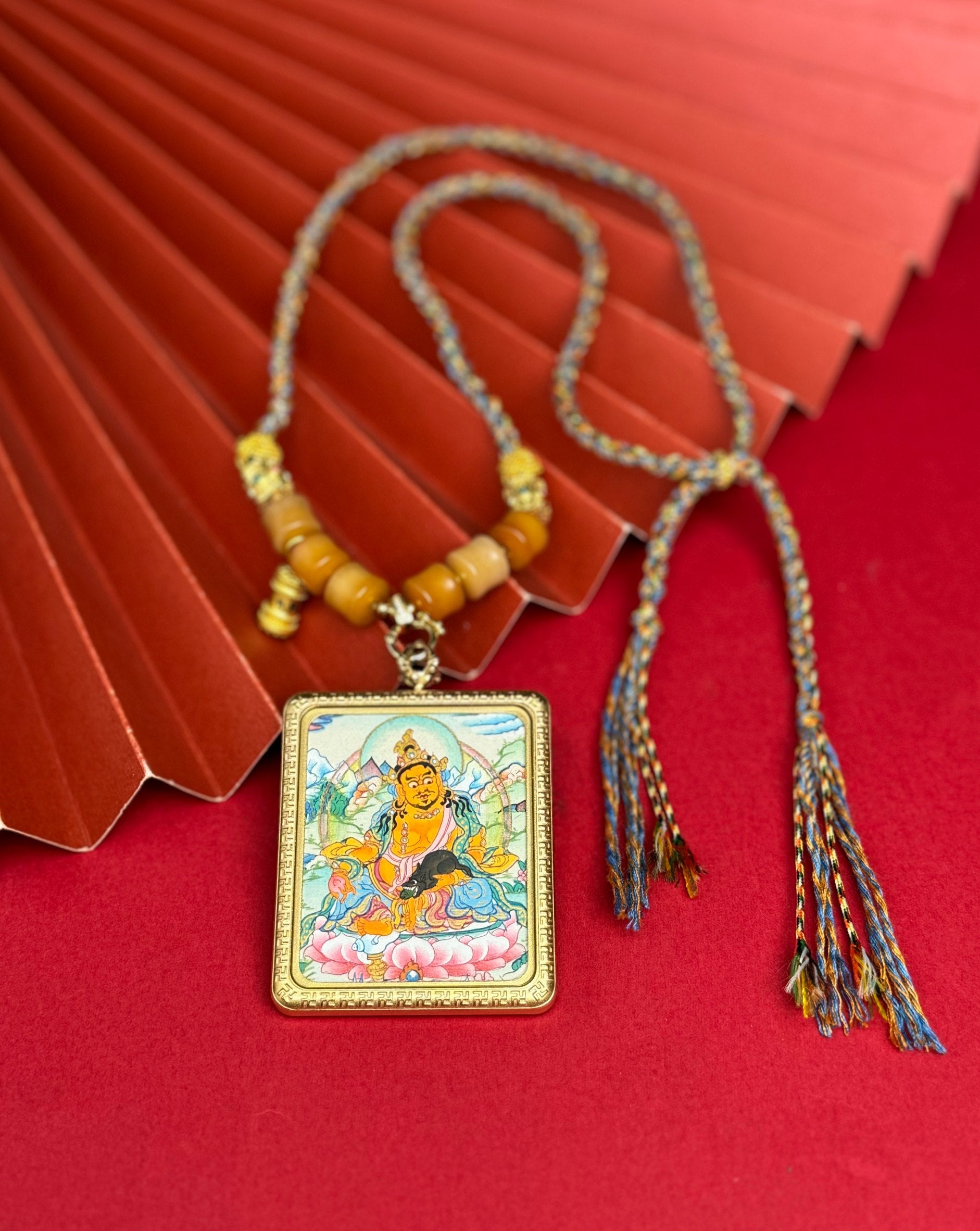  Hand-painted Nepal Yellow Jambhala (黄财神) Thangka pendant 4x5cm with titanium casing featuring the king of wealth deities, representing prosperity in Buddhist tradition.
