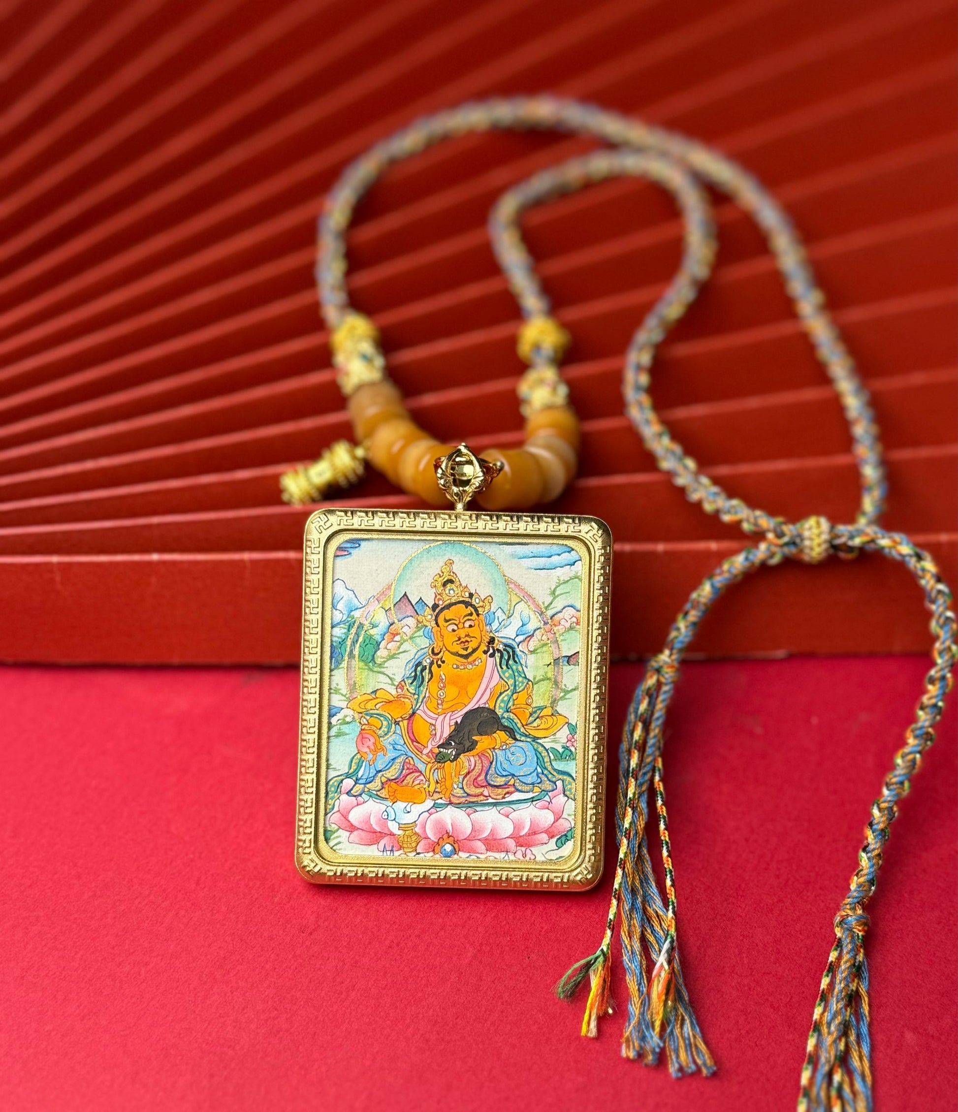  Close-up detail of the Nepal Yellow Jambhala Thangka showing hand-painted mineral pigments, showcasing the masterful artistry and vivid expression.
