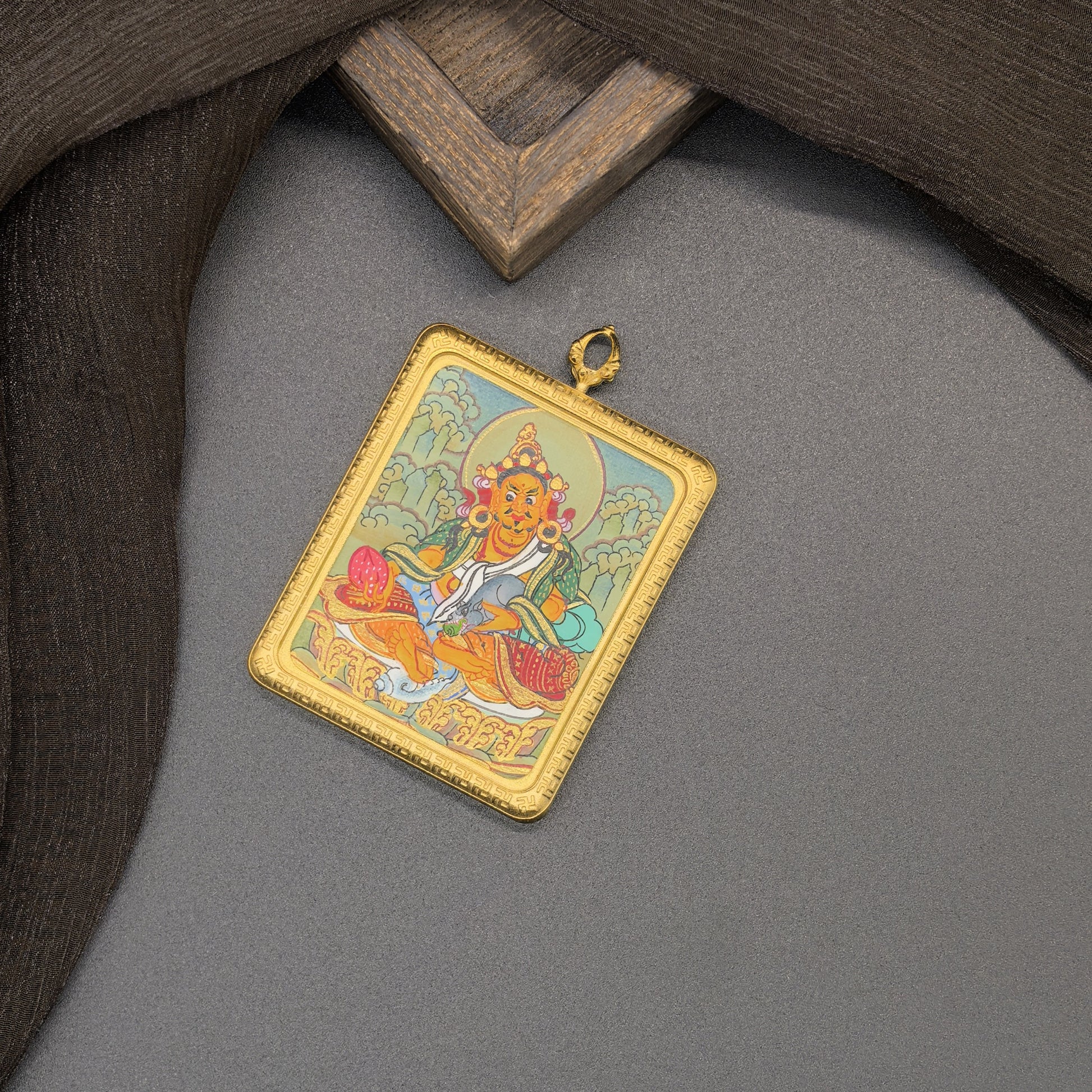  The Nepal Yellow Jambhala Thangka pendant with titanium casing displayed as a sacred amulet for prosperity and the bestowal of wealth, embodying Buddhist tradition.
