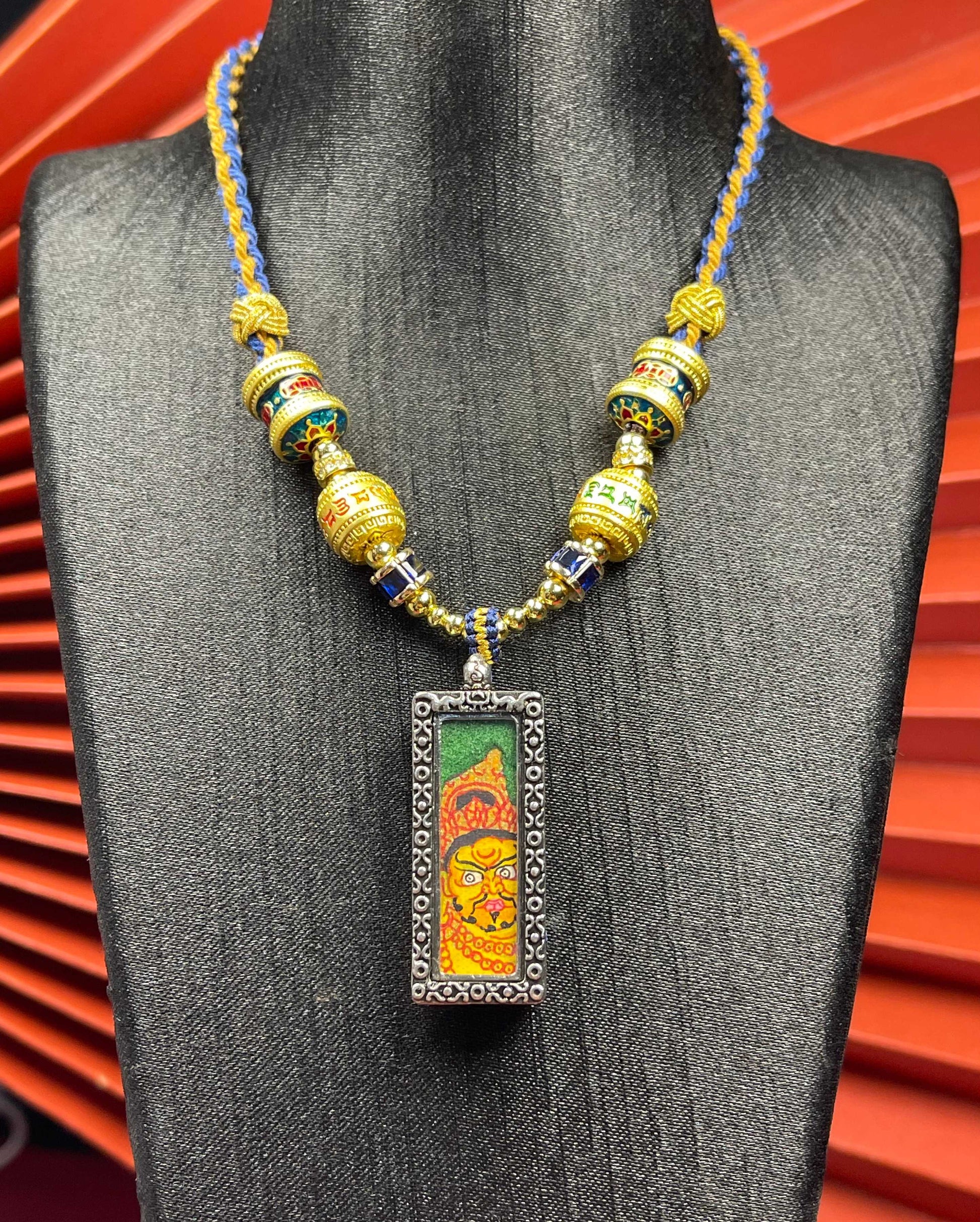  Close-up detail of the Nepal Green Base Yellow Jambhala Thangka showing hand-painted mineral pigments, showcasing the masterful artistry.
