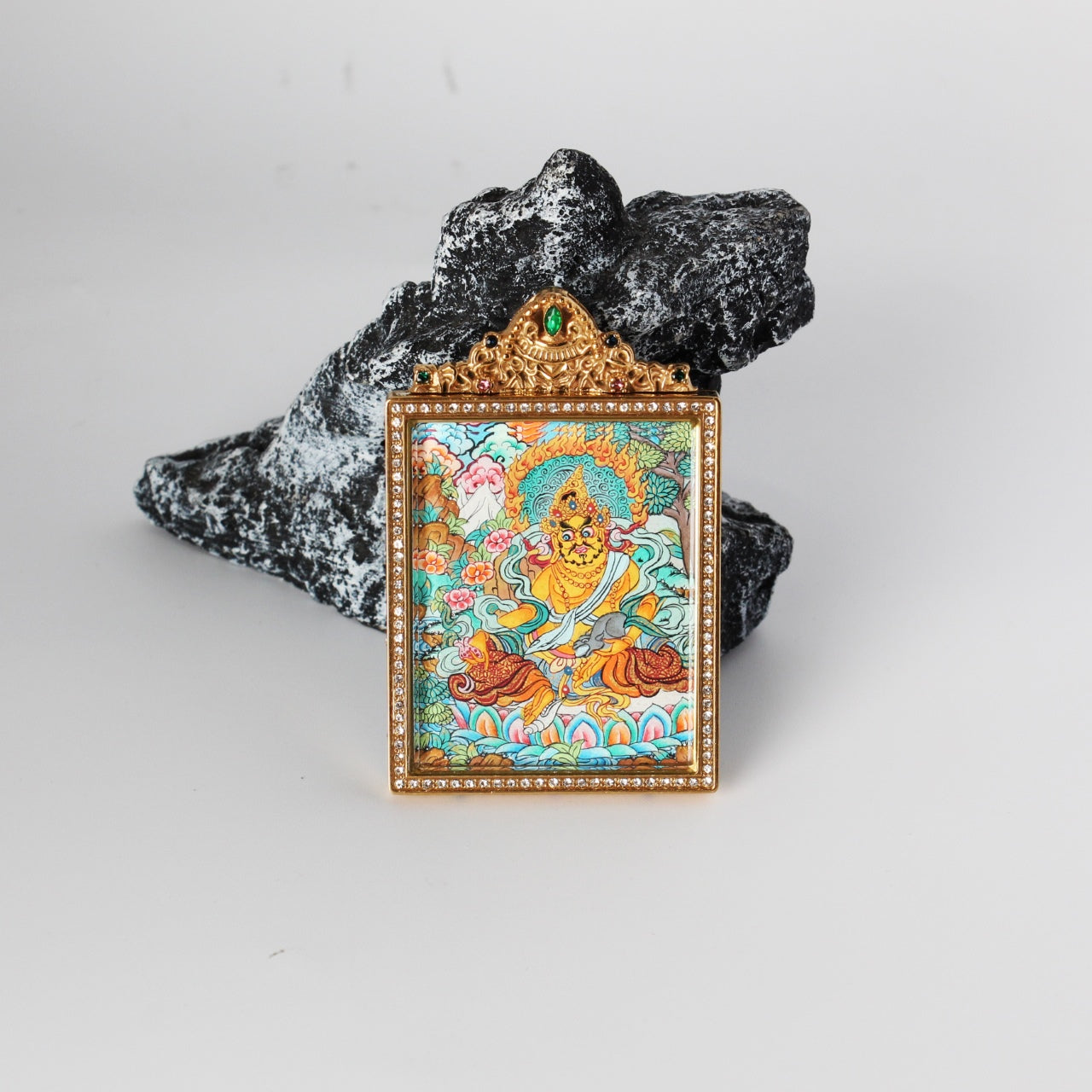 Detailed view of the titanium steel casing for the Yellow Jambhala Thangka pendant, symbolizing protection and elegance in Tibetan Buddhist tradition.

