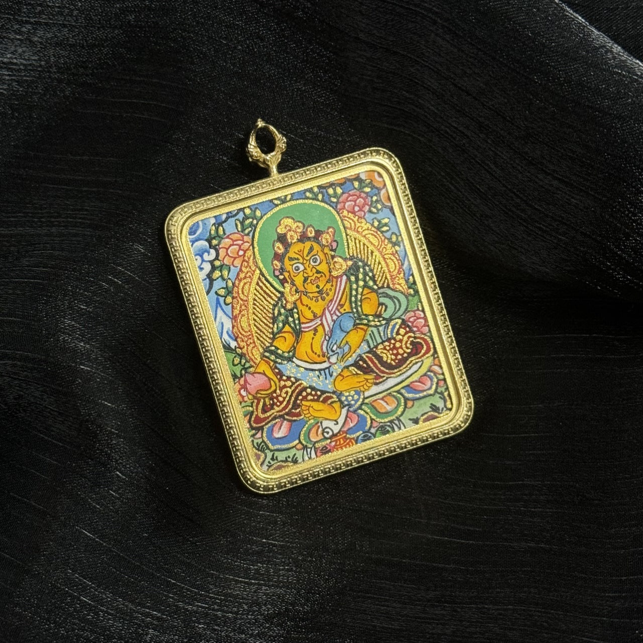  The Nepal Yellow Jambhala Thangka pendant displayed as a sacred amulet for wealth and career, embodying Buddhist tradition.
