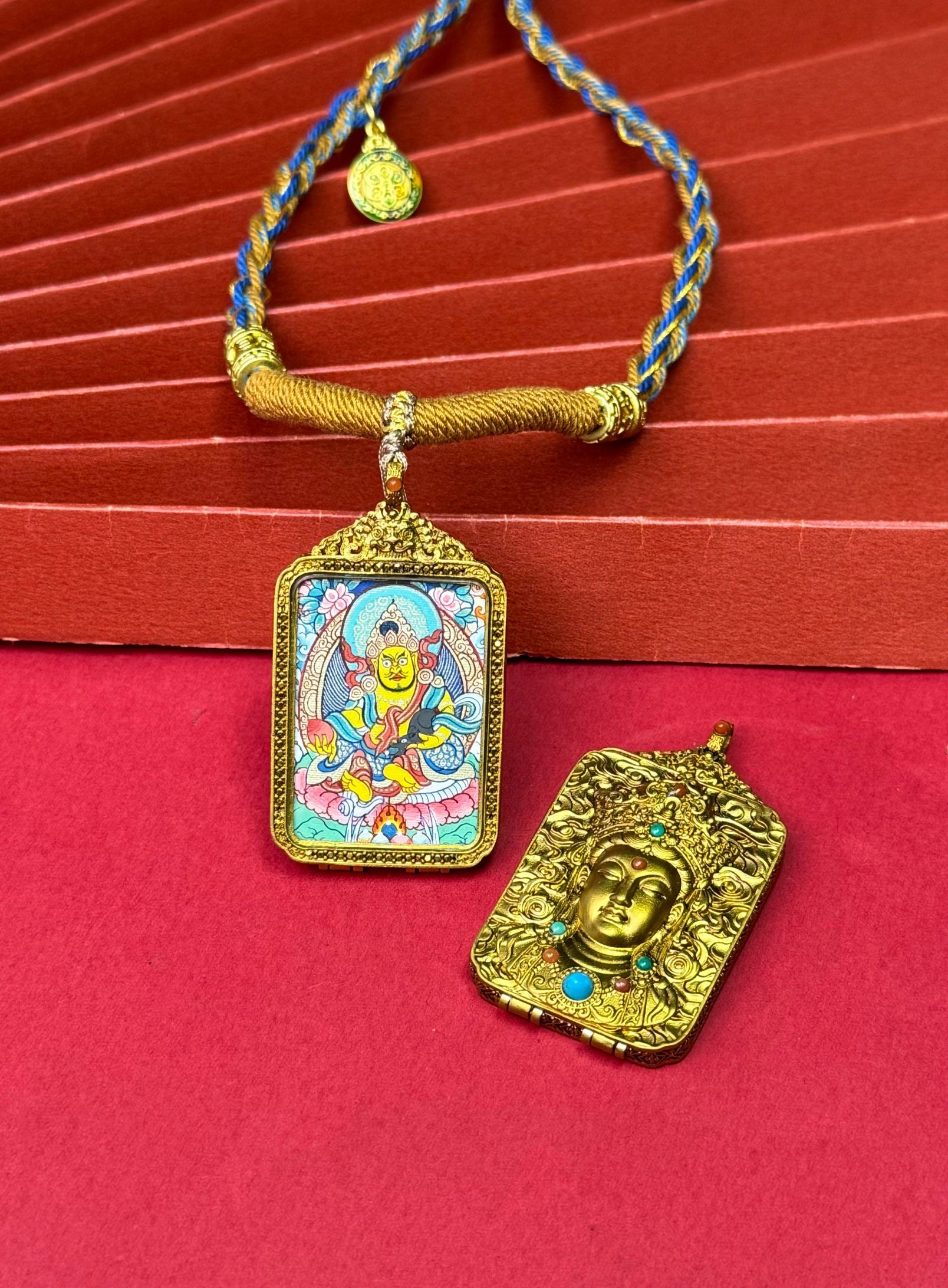 Hand-painted Rekong Yellow Jambhala (黄财神) Thangka pendant 2.5x3.5cm with copper casing featuring the king of wealth deities, representing prosperity in Buddhist tradition.
