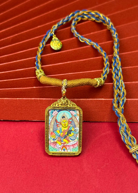 Detailed view of the refined copper casing for the Yellow Jambhala Thangka pendant, symbolising wealth and tradition in Buddhist practice.
