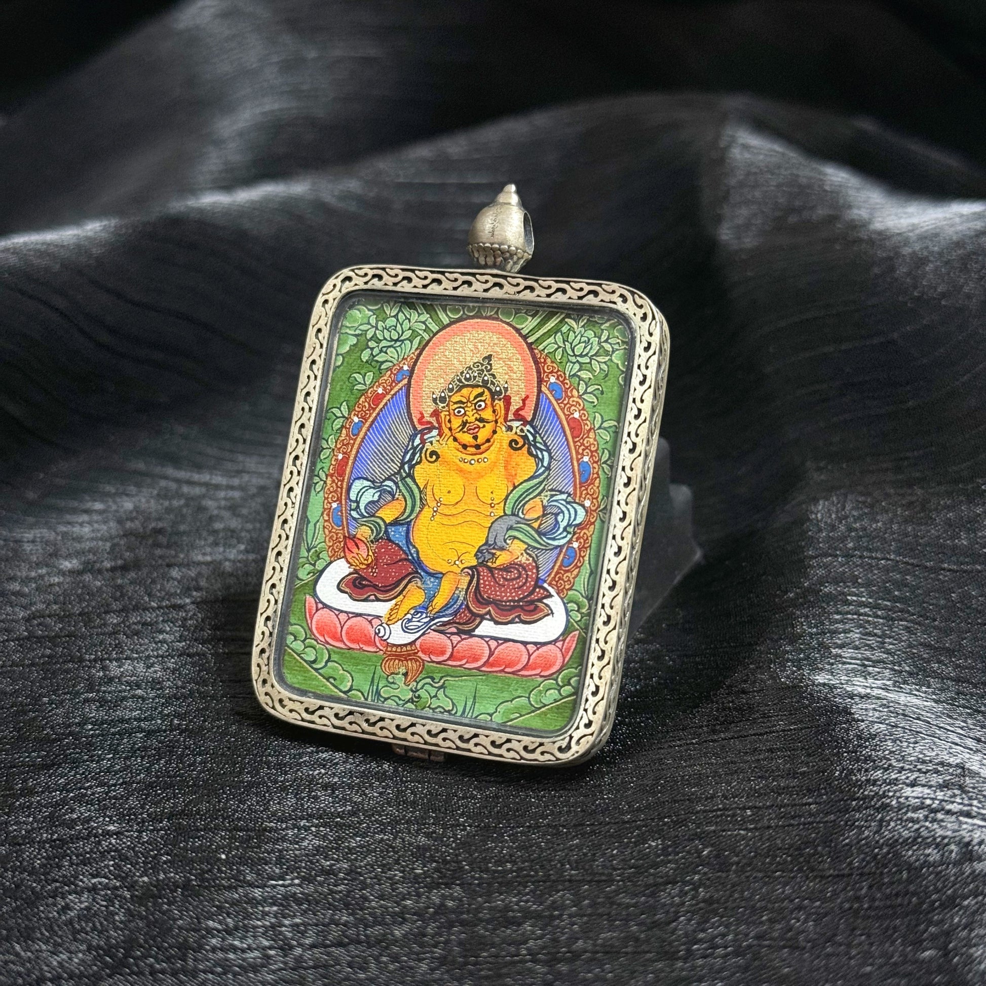  The Rekong Cuiying Yellow Jambhala Thangka pendant displayed as a sacred amulet for wealth and prosperity.
