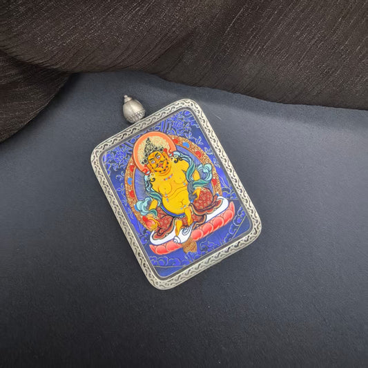 A 3.5x4.5cm hand-painted Rekong Blue Thangka Yellow Jambhala (黄财神瞻巴拉) Thangka pendant with 925 silver featuring the king of wealth deities, representing wealth and prosperity in Buddhist tradition.
