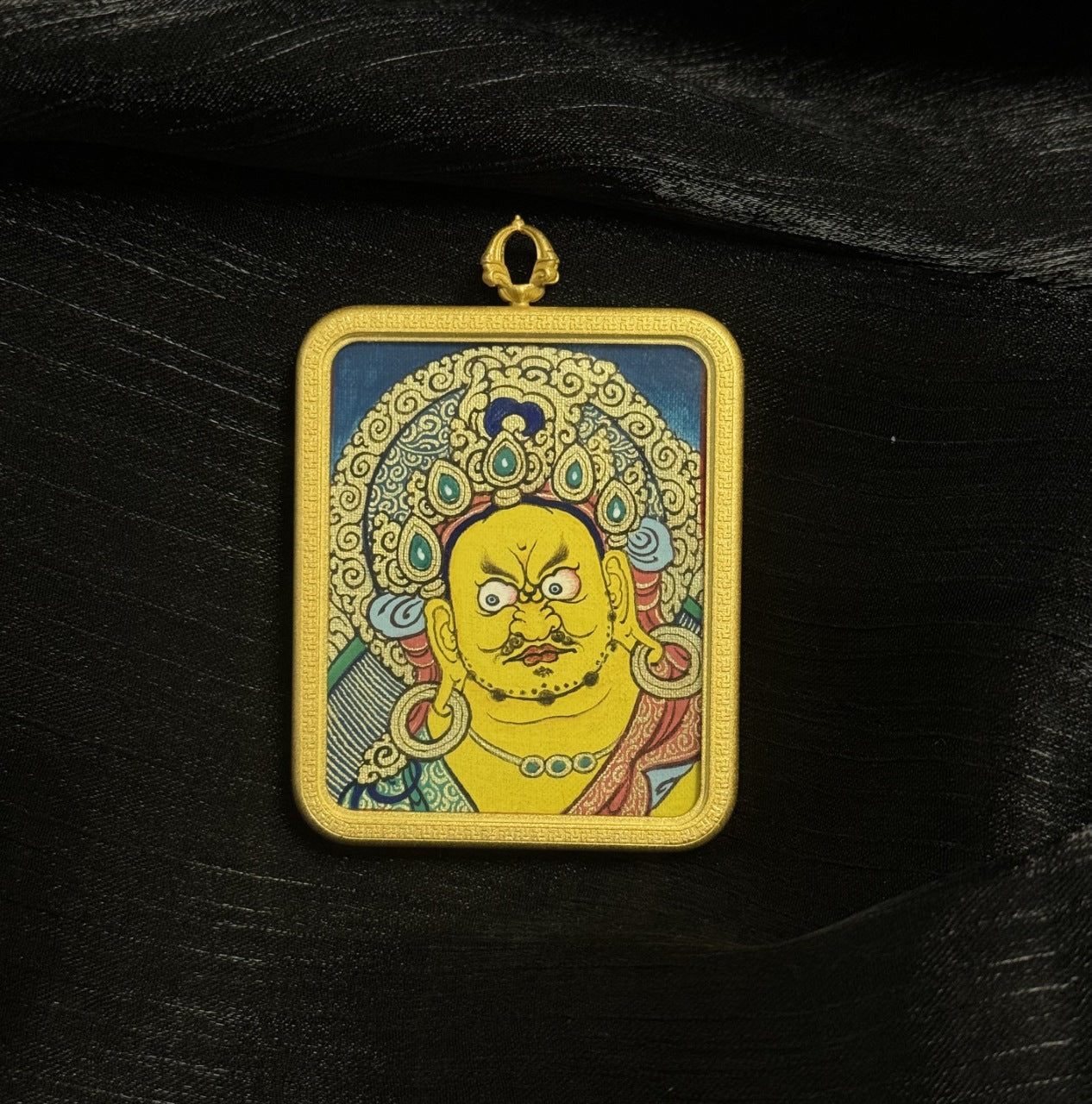 Detailed view of the protective casing for the Yellow Jambhala Thangka pendant, symbolising protection and tradition in Buddhist practice.