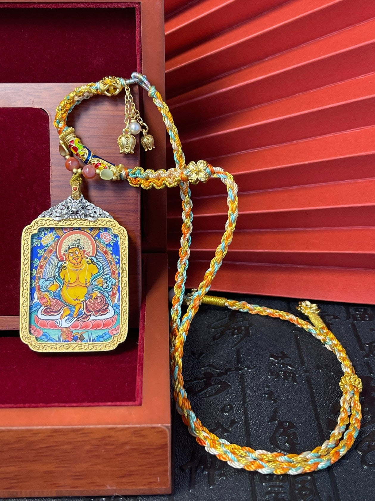 Close-up detail of the Rekong Yellow Jambhala Thangka showing natural mineral pigments, Rekong series artistry.
