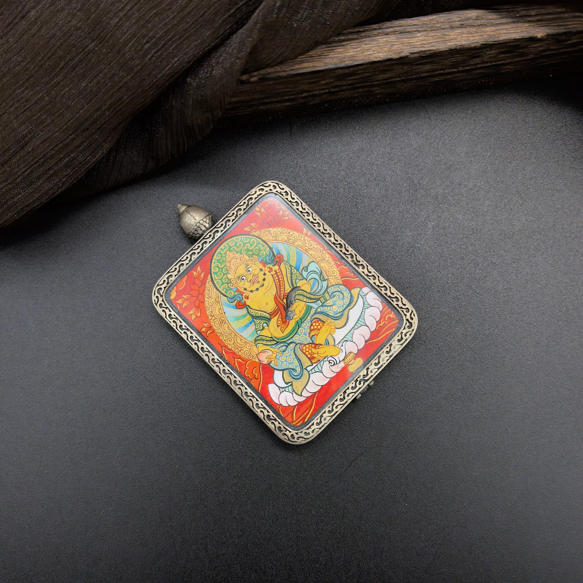  A 4x5cm hand-painted Rekong Red Yellow Jambhala (黄财神) Thangka pendant featuring the chief of wealth deities, representing wealth and fortune in Buddhist tradition.

