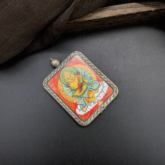  A 4x5cm hand-painted Rekong Red Yellow Jambhala (黄财神) Thangka pendant featuring the chief of wealth deities, representing wealth and fortune in Buddhist tradition.
