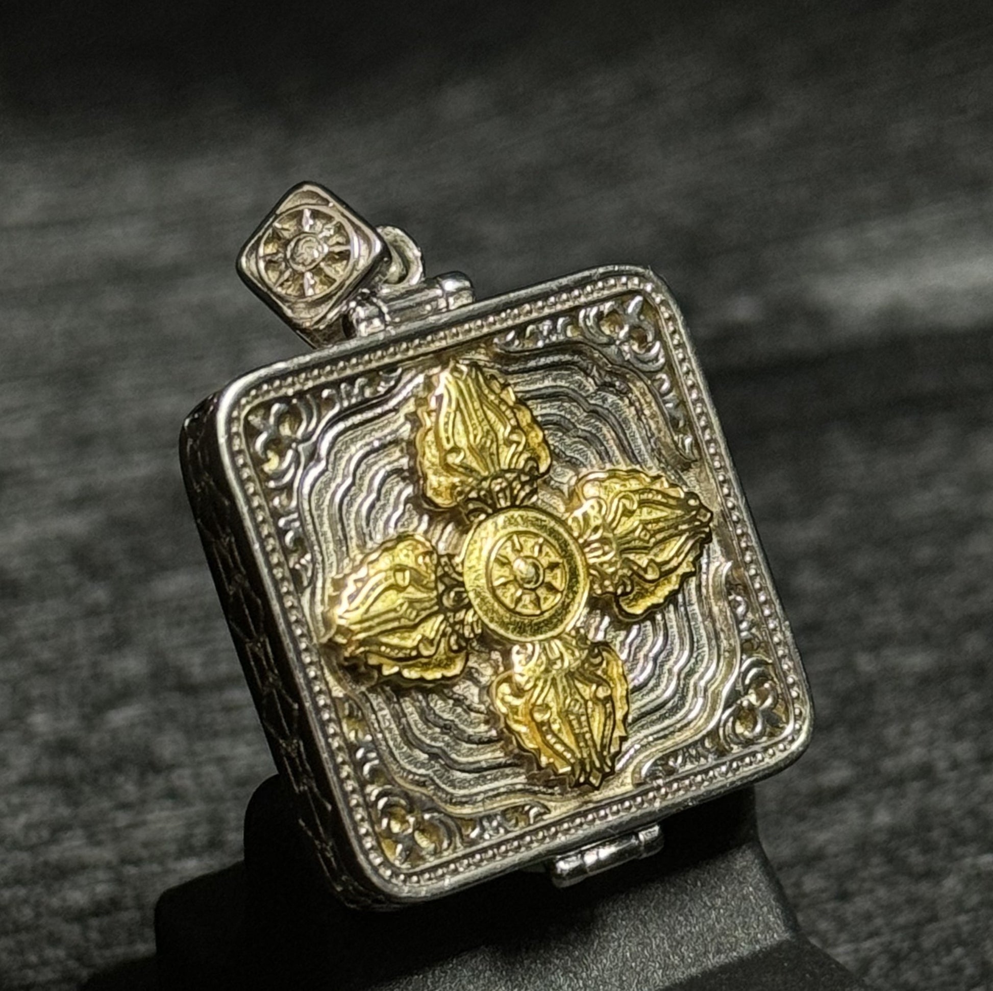  The Rekong Yellow Jambhala Thangka pendant displayed as a sacred amulet for wealth and fortune, embodying Buddhist tradition.

