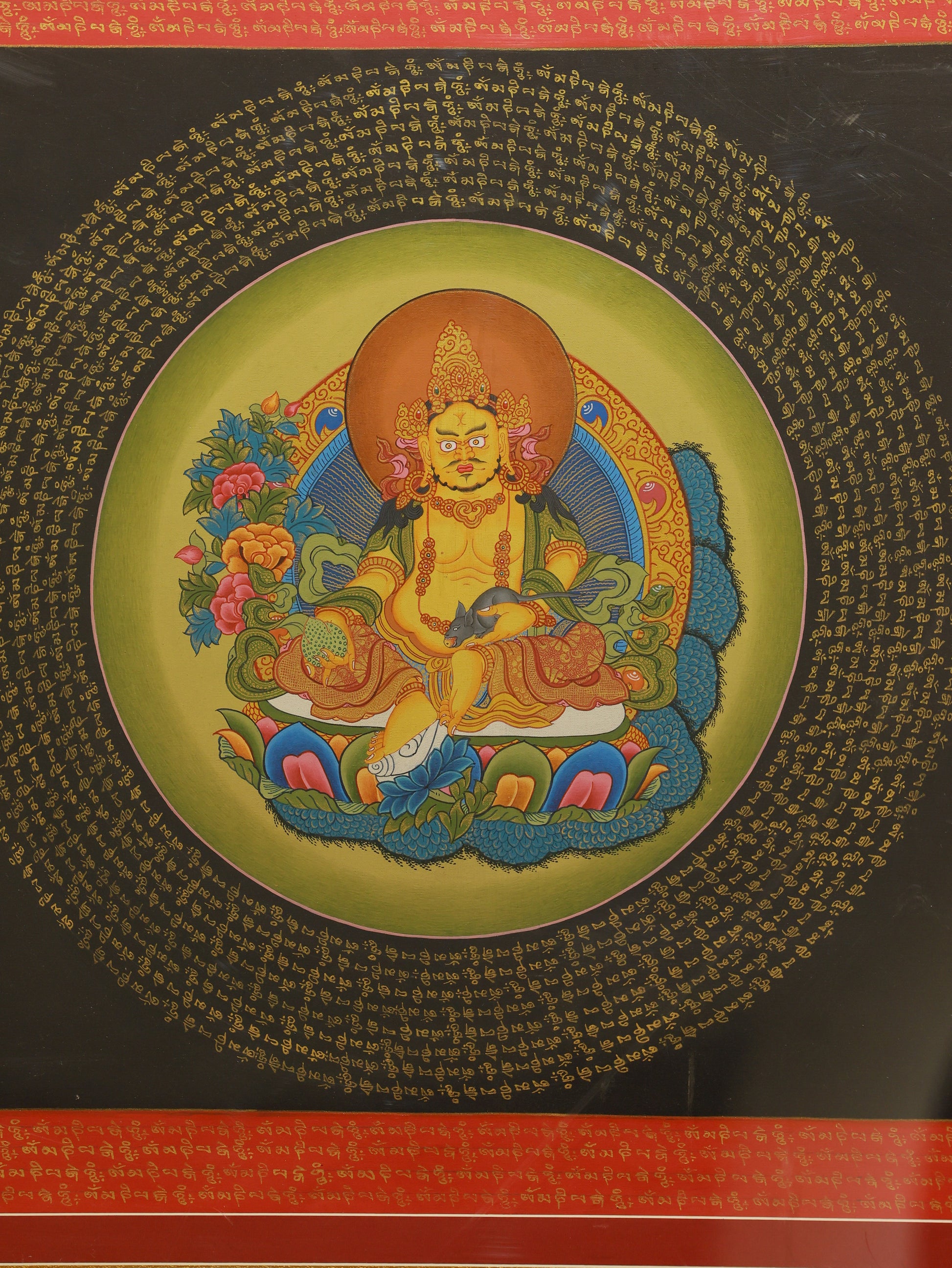 Yellow Jambhala Thangka painting featuring the Six Syllable Mantra, Tibetan Buddhist sacred artwork for prosperity.