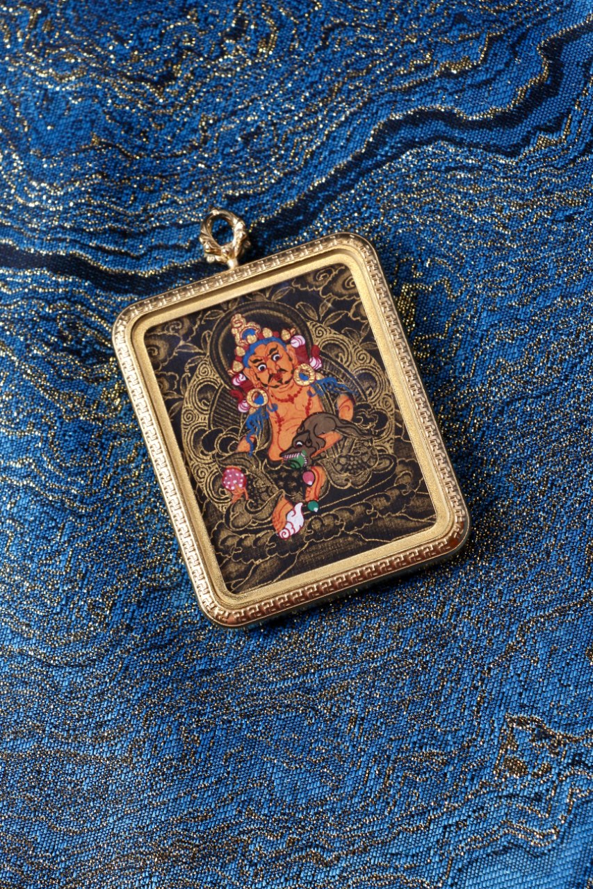 Yellow Jambhala thangka amulet used in Tibetan Buddhism to attract wealth, success, and remove financial obstacles.