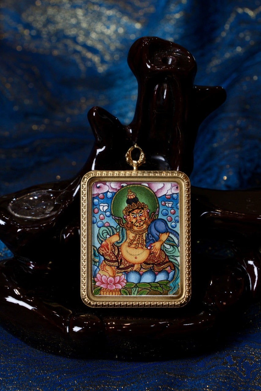 Artwork of a Yellow Jambhala Thangka Pendant, a symbol of abundance in Tibetan Buddhist tradition.