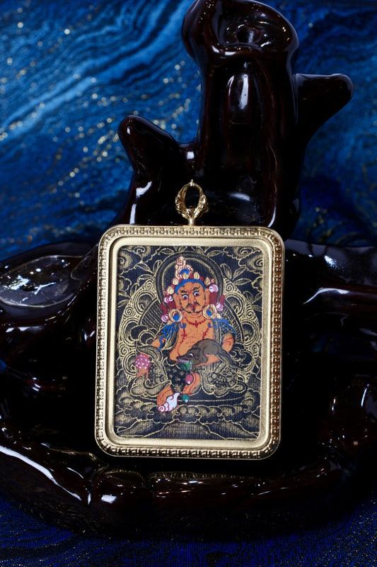 Tibetan thangka jewelry featuring Yellow Dzambhala, inspired by traditional Tibetan Buddhist sacred art and wealth symbolism.