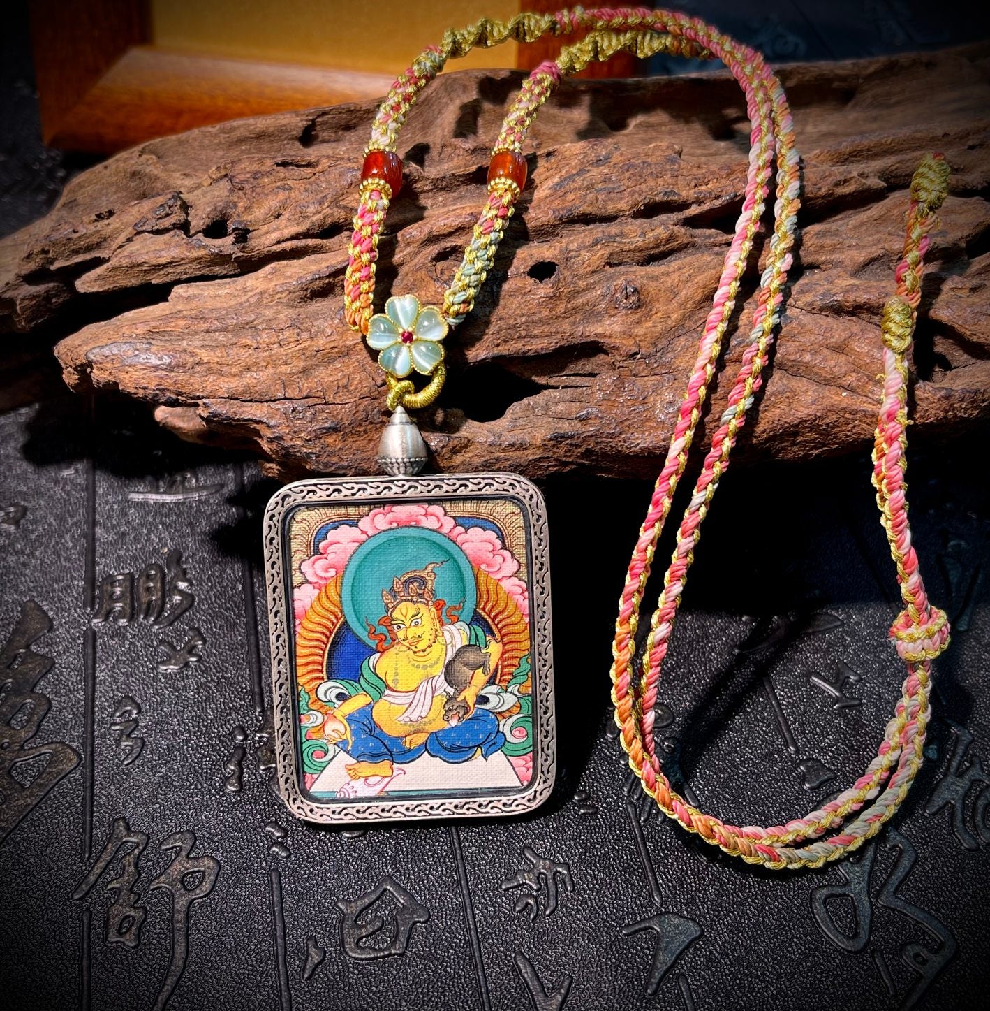 Detailed view of the Dunhuang Nine-Color Deer silver casing for the Yellow Jambhala Thangka pendant, symbolising wealth and tradition in Buddhist practice.


