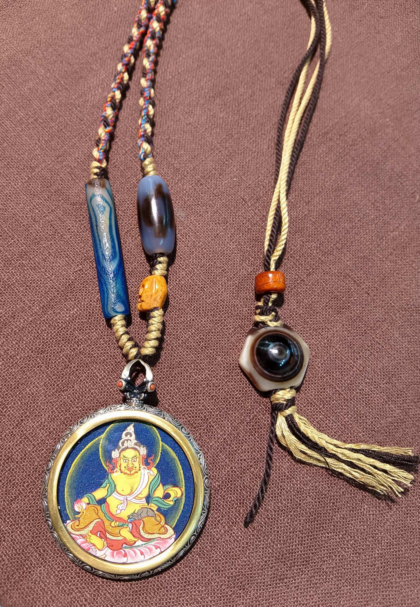  The Tibet Card Yellow Jambhala 3.5cm pendant with 925 silver and optional dzi lapis necklace displayed as an amulet for wealth and career.

