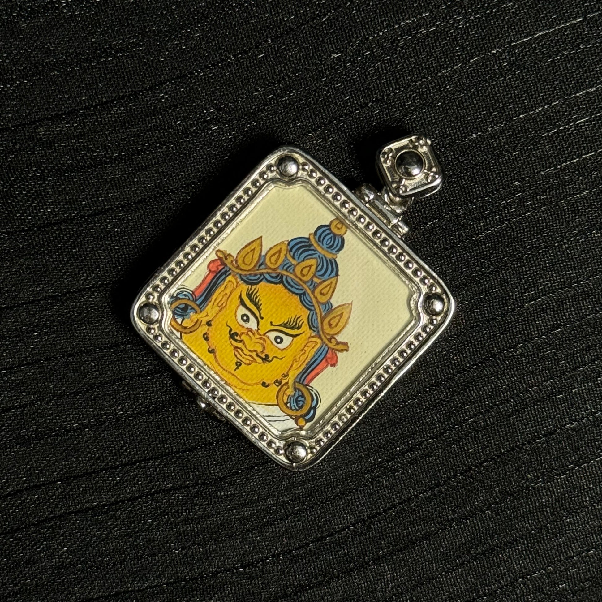  Close-up detail of the Tibet Yellow Jambhala Thangka painting showing natural mineral pigments, showcasing the masterful artistry of Tibetan lineage painters.

