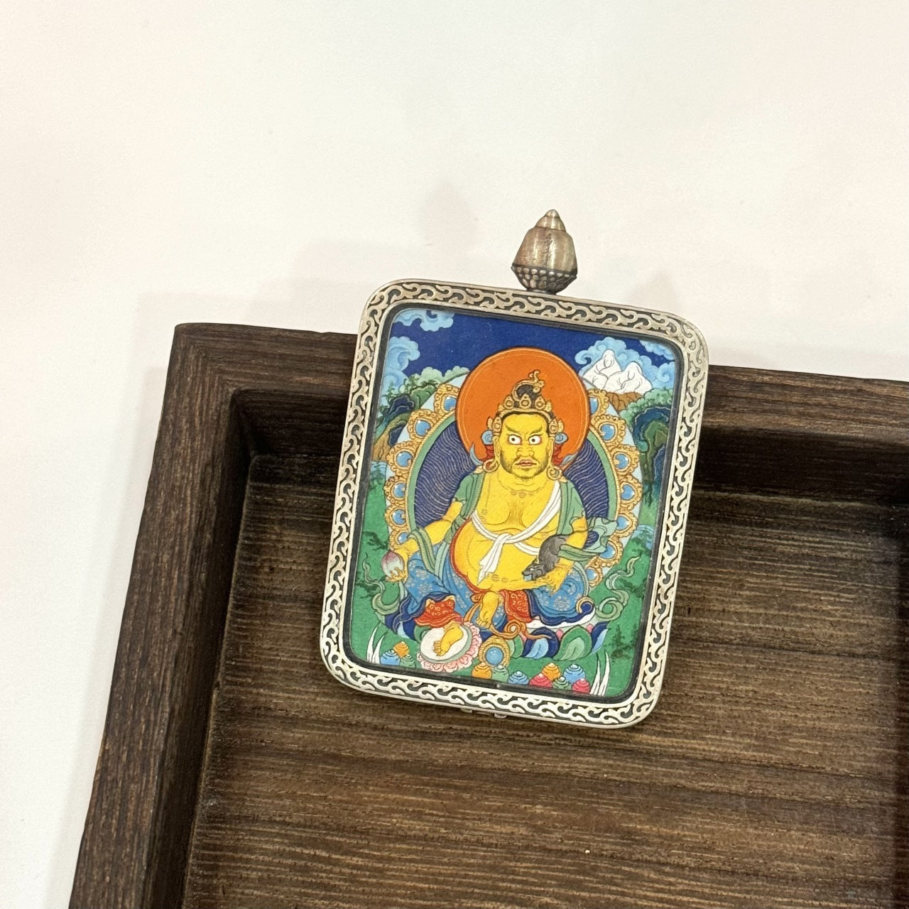  Close-up detail of the Tibet Miansa Yellow Jambhala Thangka painting showing intricate natural mineral pigment work, showcasing the masterful artistry of Tibetan Miansa lineage painters.

