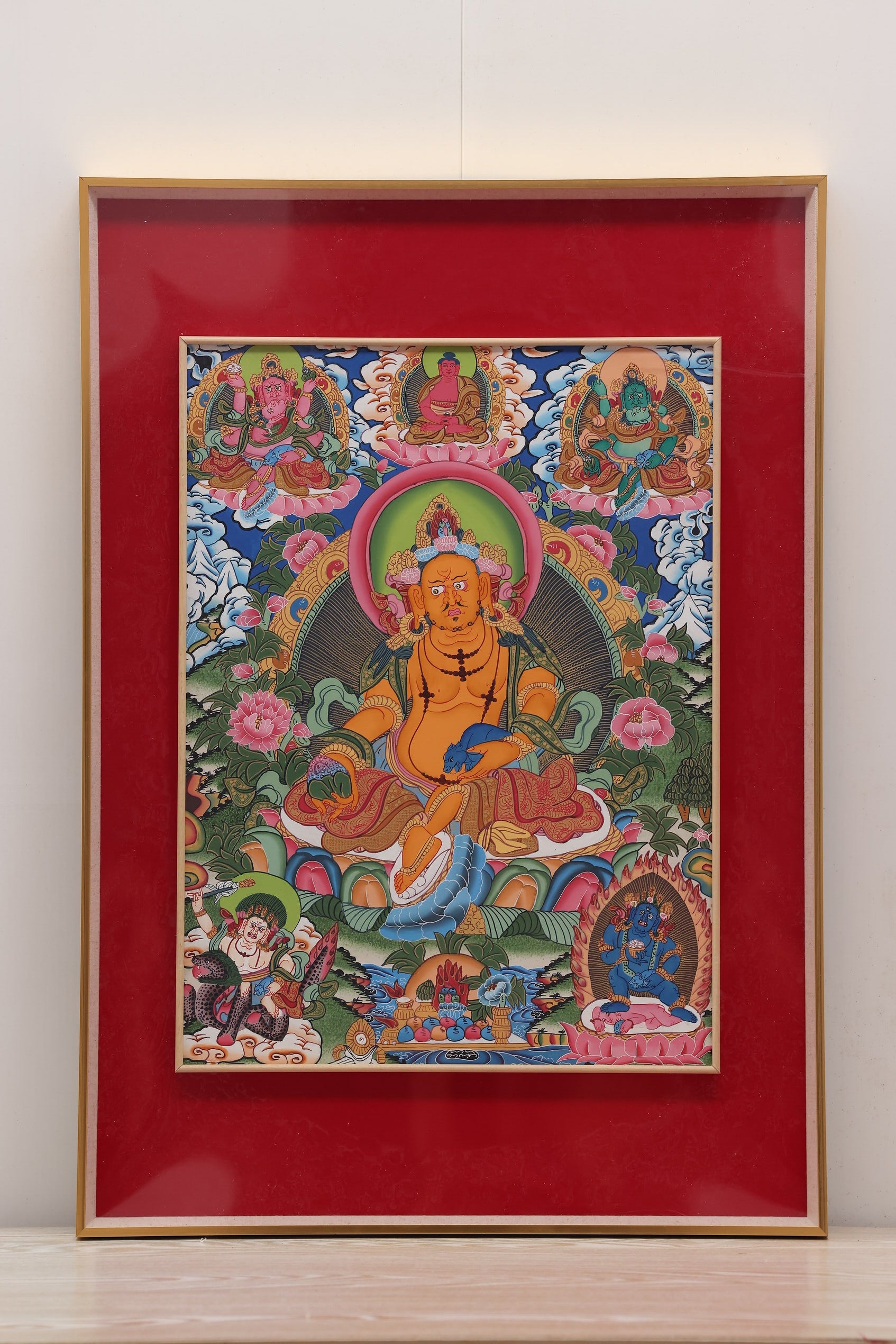 Yellow Jambhala standing on a lotus, representing spiritual and material abundance in Tibetan Buddhism.