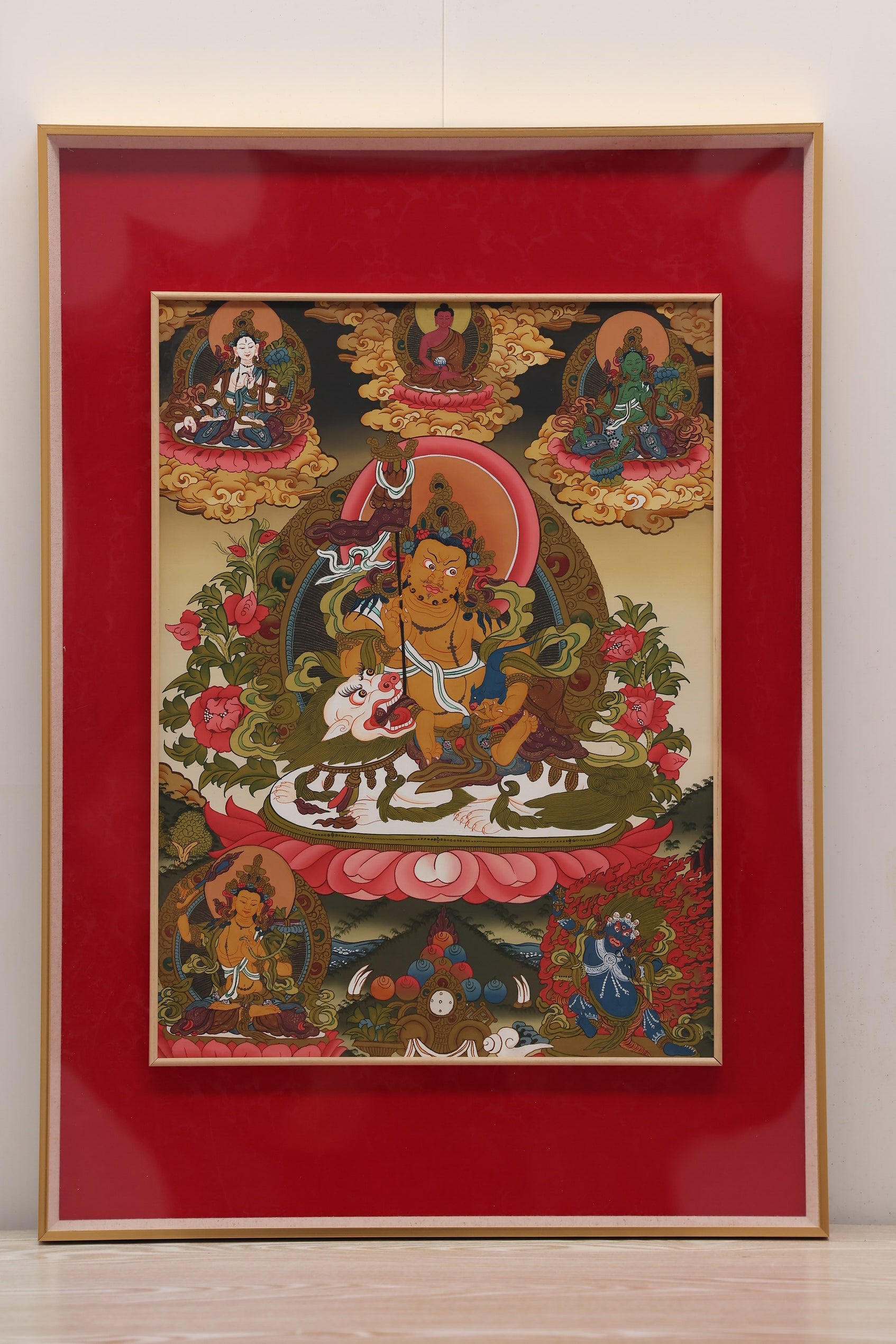 Golden-toned Yellow Jambhala thangka symbolizing abundance, merit, and financial stability