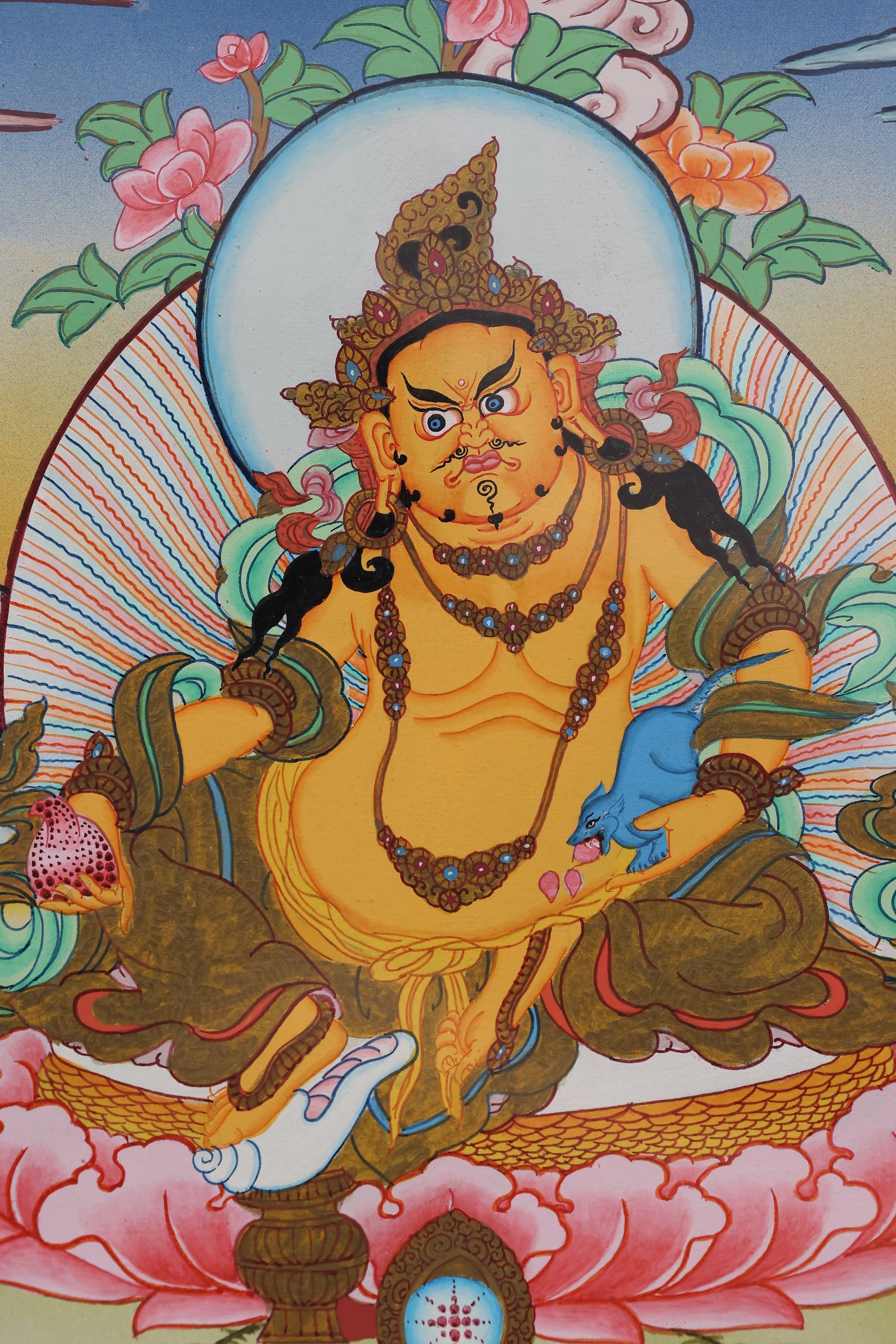 Hand-painted color thangka of Yellow Jambhala, the Tibetan Buddhist god of wealth and abundance.