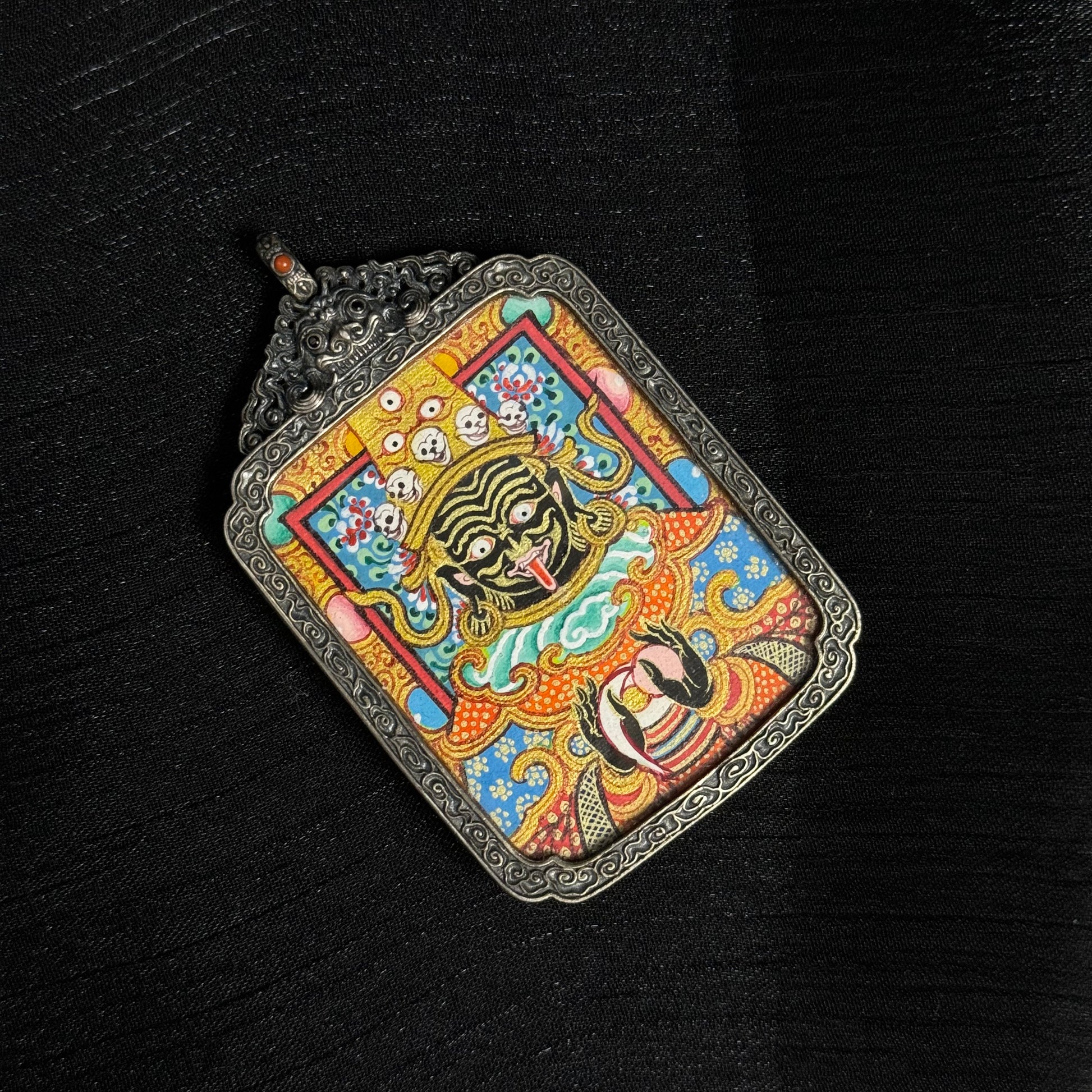  The Rekong Zaki Lhamo Thangka pendant displayed as a sacred amulet for wealth and fortune, embodying Buddhist tradition.
