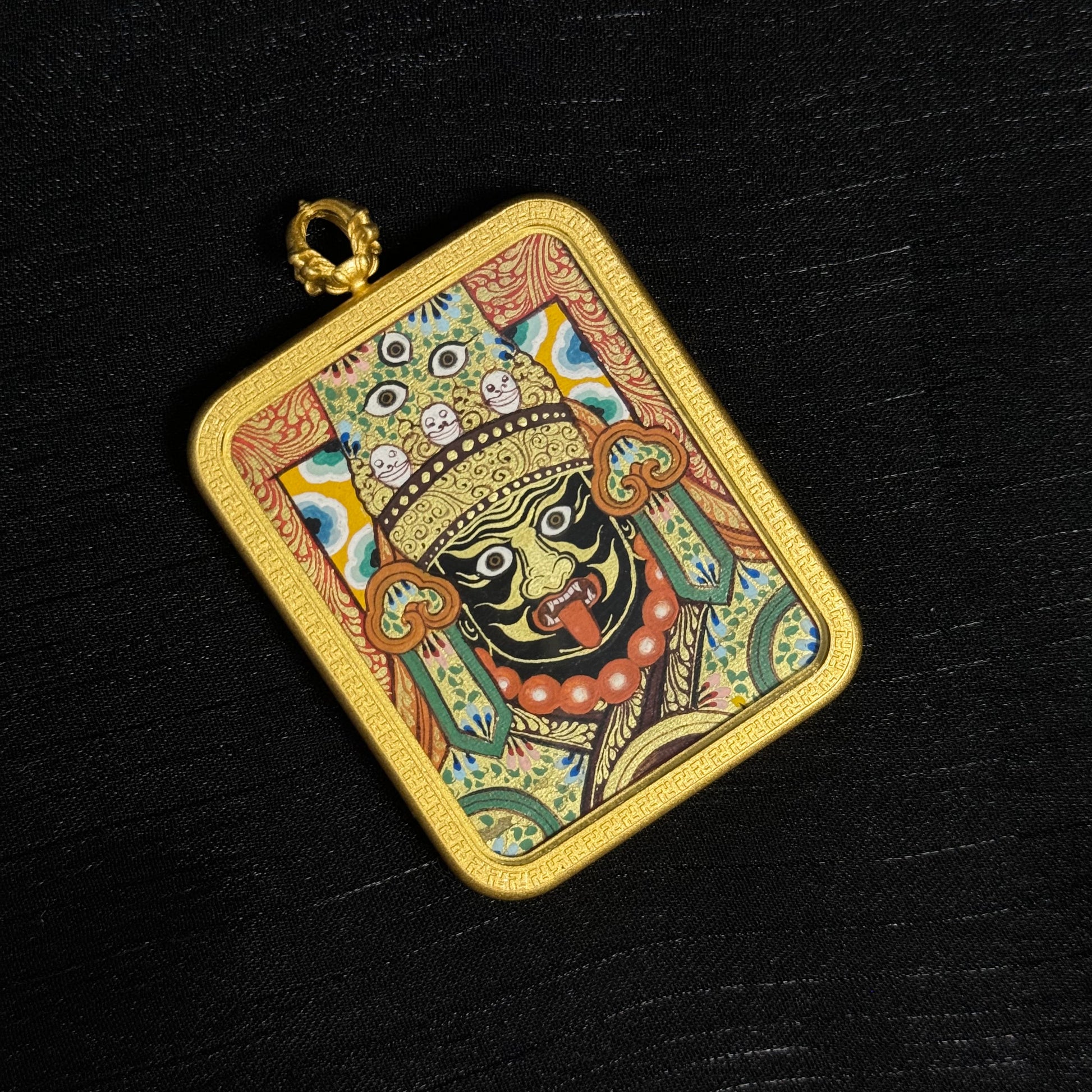  The Rekong Zaki Lhamo Thangka pendant displayed as a sacred amulet for wealth and protection, embodying Buddhist tradition.
