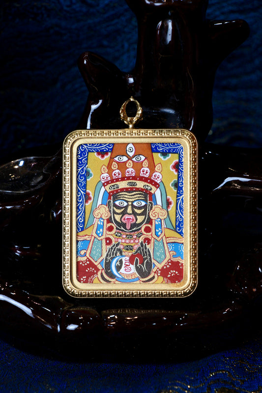 A sacred hand-painted Zaki Lhamo (Female Wealth Deity) Thangka pendant on a blue background from Regong, encased in a titanium steel frame.