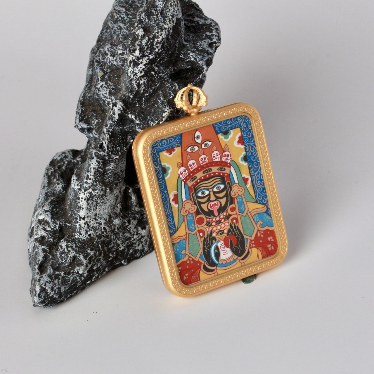  The Rebgong Zhagilhamo Thangka pendant displayed as a sacred amulet for wealth and protection, embodying Tibetan Buddhist tradition.
