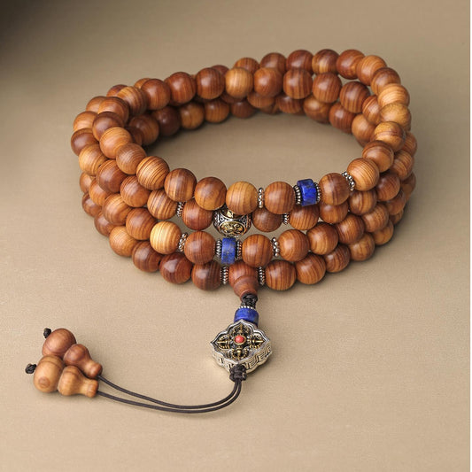 Handmade Tibetan Buddhist cypress wood 108-bead mala with lapis lazuli and brass for prosperity and spiritual practice.