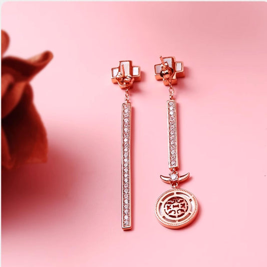 Handcrafted Tibetan Buddhist dragon blessing earrings with mother of pearl and cubic zirconia, symbolizing fortune and strength.