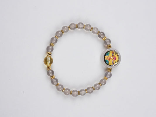 Handcrafted Tibetan-Buddhist Yellow Dzambhala mini Thangka bracelet painted on thangka canvas with mineral pigments, representing wealth and prosperity in Tibetan Buddha art