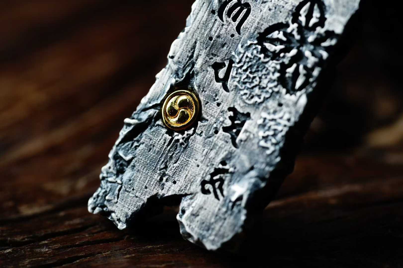 Tibetan Buddhist pendant with Eight Sacred Symbols crafted in silver and copper