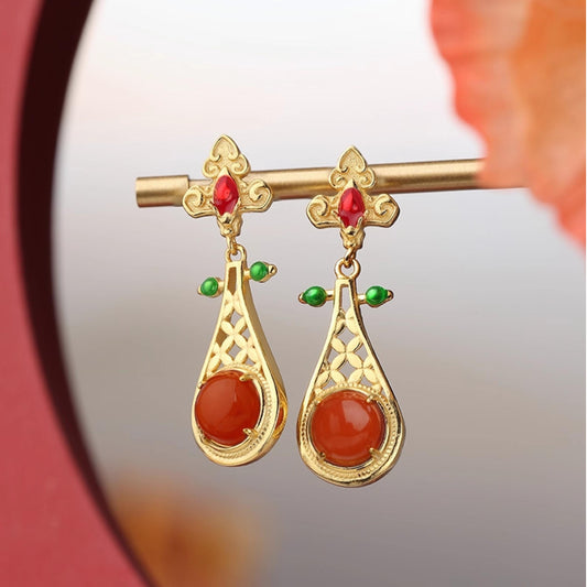 Handmade Tibetan Buddhist earrings with 925 silver and red agate, inspired by sacred jewelry art.