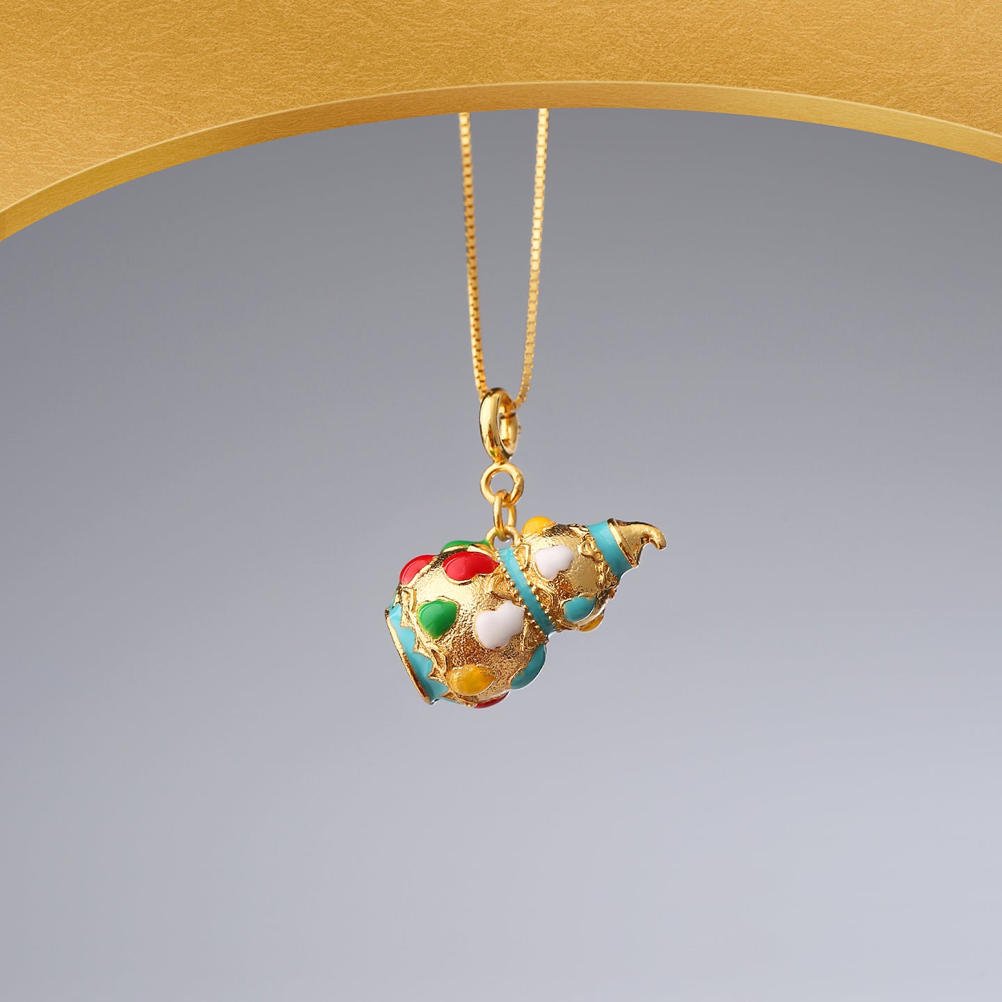 Sanskrit Harmony handcrafted pendant with colorful enamel details.