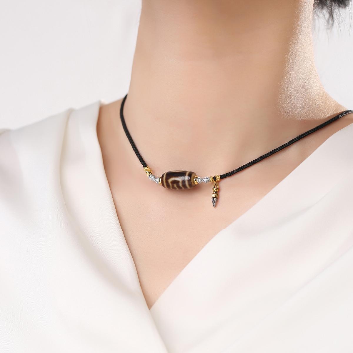 Handmade Garuda Dzi agate necklace representing fearlessness and spiritual strength.