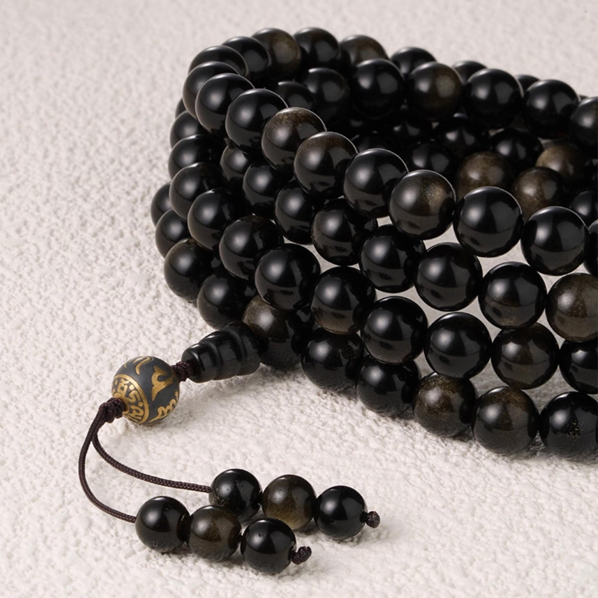 Handcrafted golden obsidian bead strand inspired by Tibetan spiritual artistry.