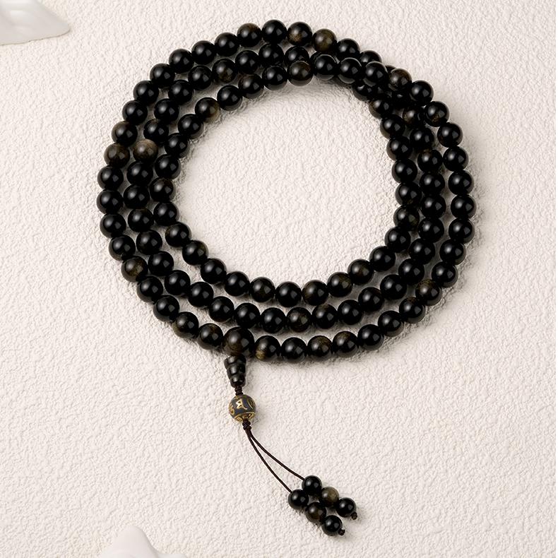 Handmade Tibetan Buddhist golden obsidian mala necklace with ash mantra beads.