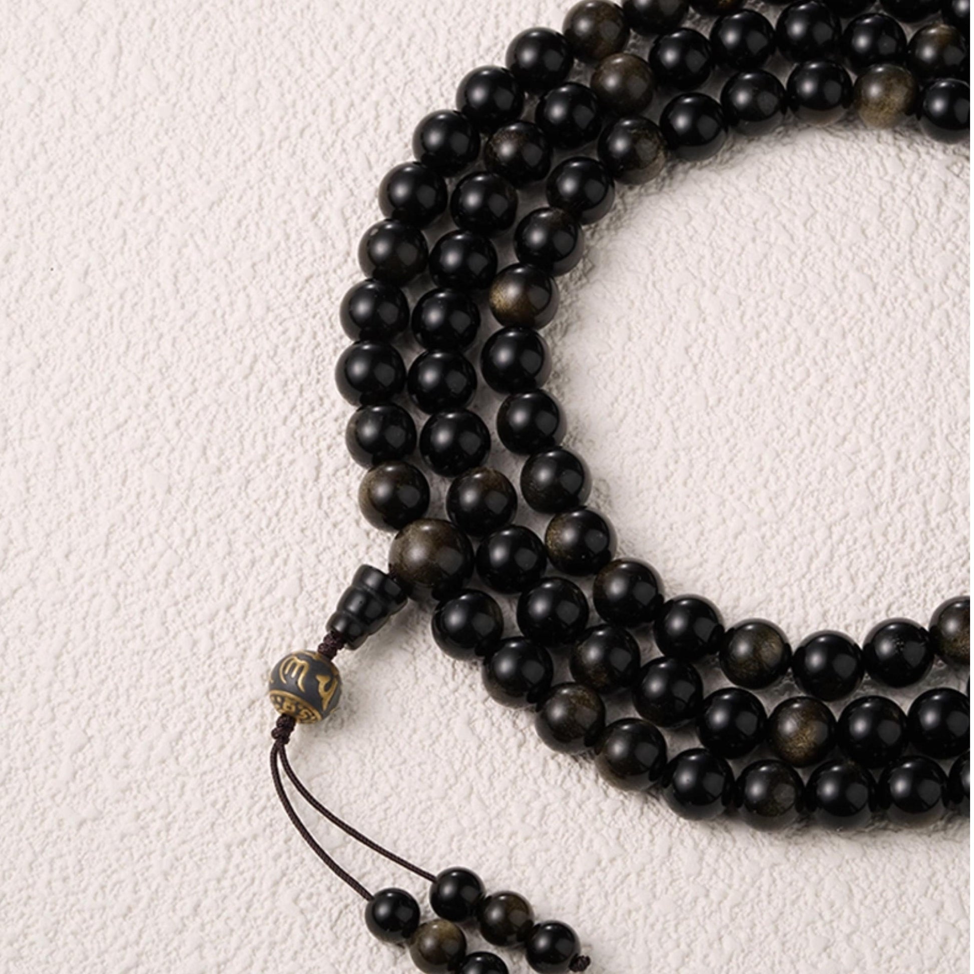 Golden obsidian spiritual necklace crafted in traditional Tibetan jewelry style.