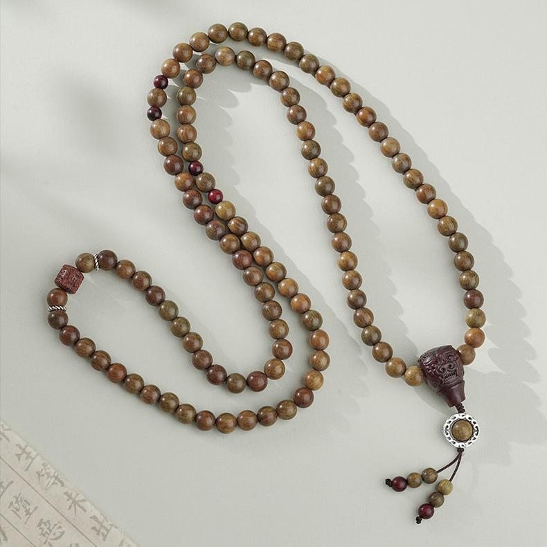 Artisanal Tibetan Buddhist bracelet crafted with green sandalwood, bloodwood, and purple sandal beads.