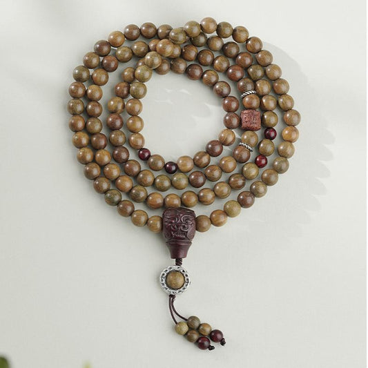 Handmade Tibetan Buddhist green sandalwood bead bracelet with bloodwood and silver accents.