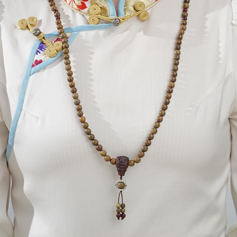 Tibetan-style bracelet featuring green sandalwood, bloodwood beads, and 925 silver spacers.