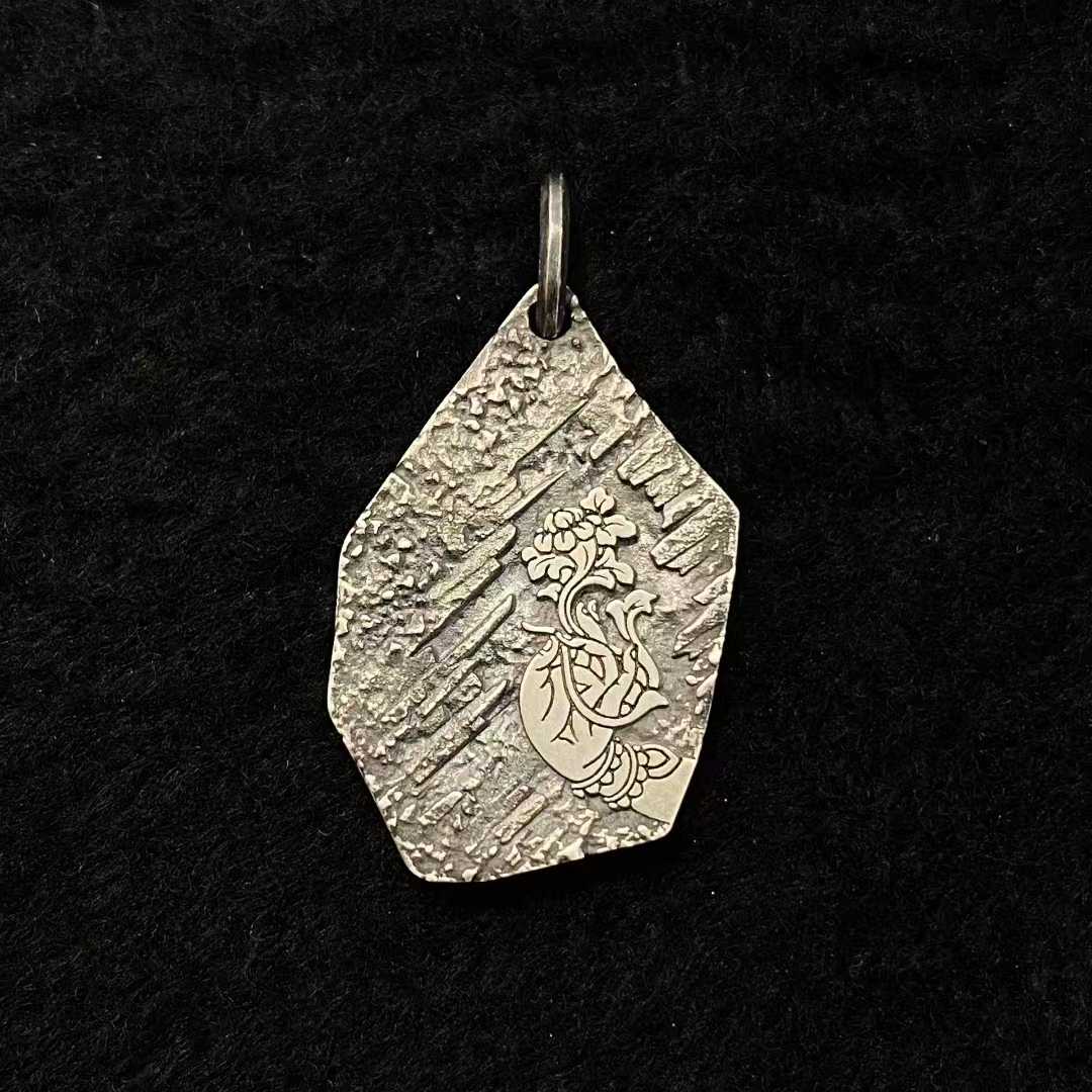 Gold and silver Green Tara sacred pendant featuring detailed Tibetan Buddhist artistry.