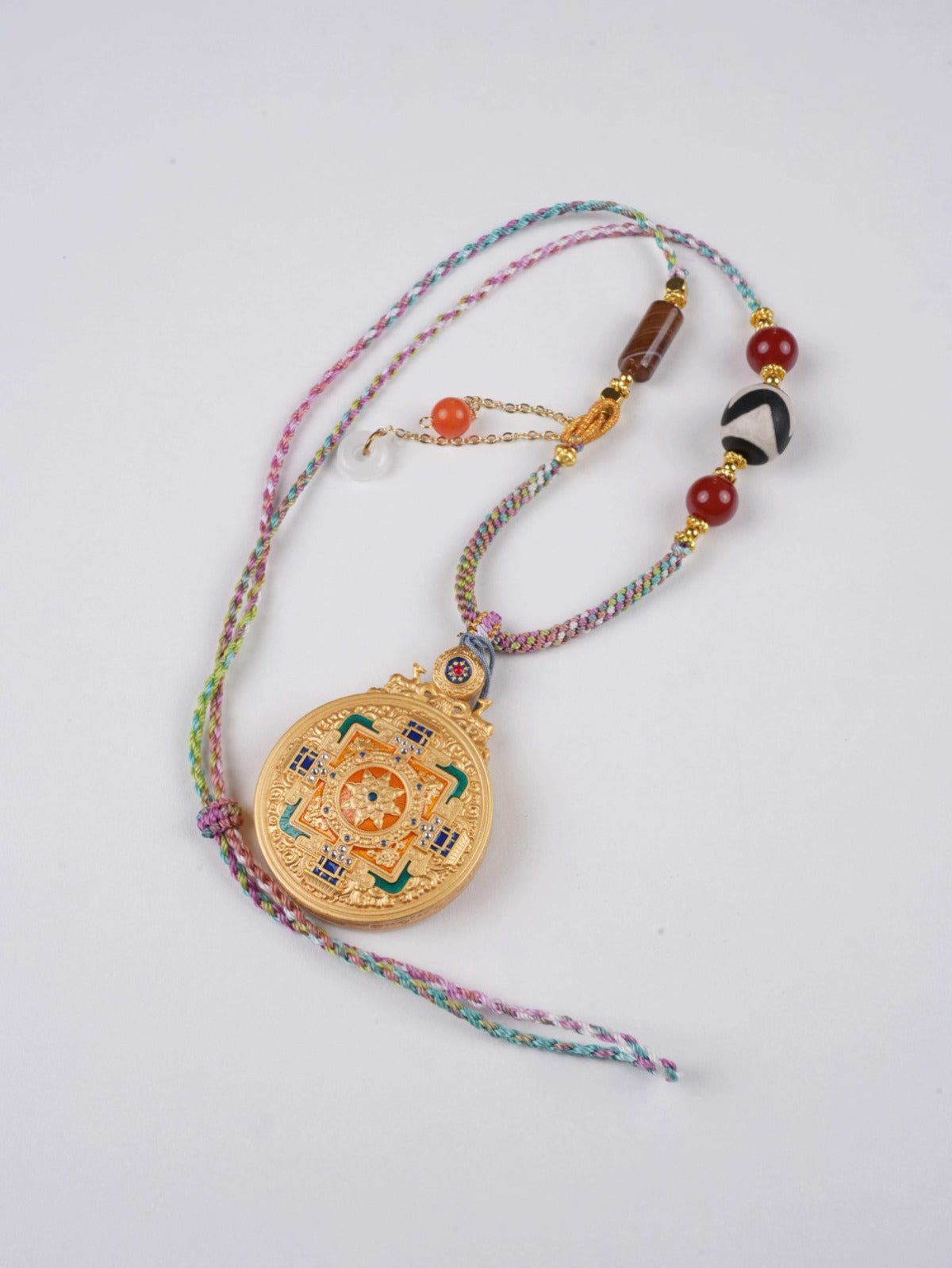 Miniature Green Tara Thangka pendant handcrafted by Tibetan artists using natural pigments.