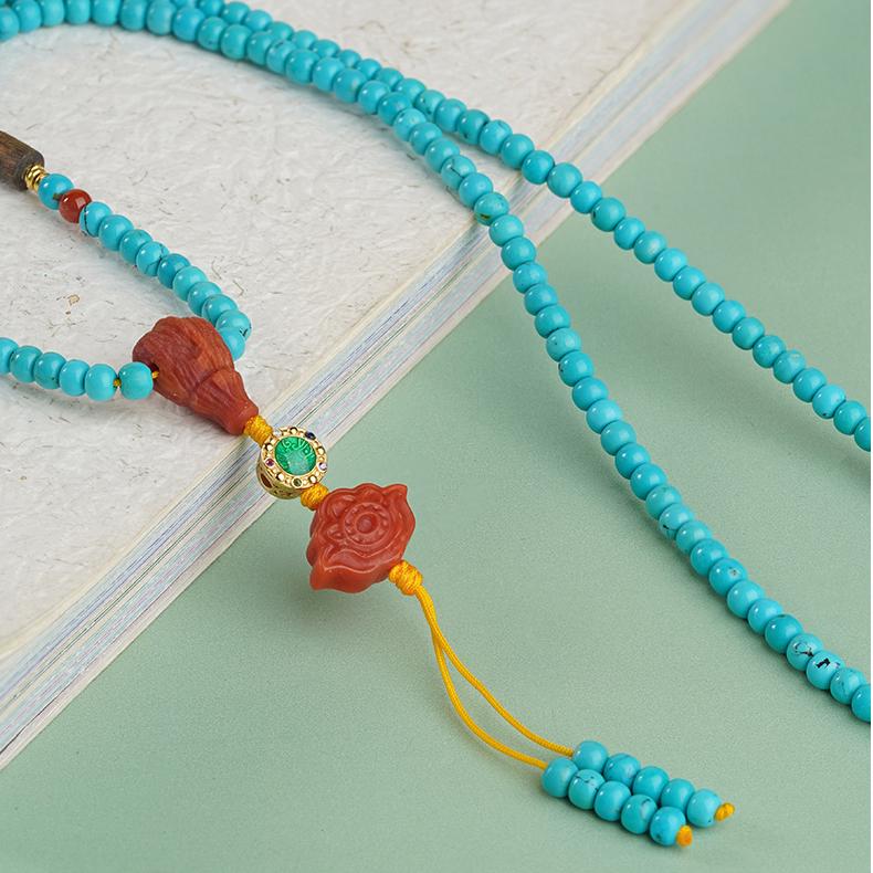 Artisan turquoise and south red necklace crafted with 925 silver and agarwood, inspired by Tibetan Buddhist design.